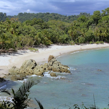 Tourists walking along beach