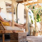 A woman relaxing by an Airstream trailer at La Caravana, Playa Carillo, Costa Rica